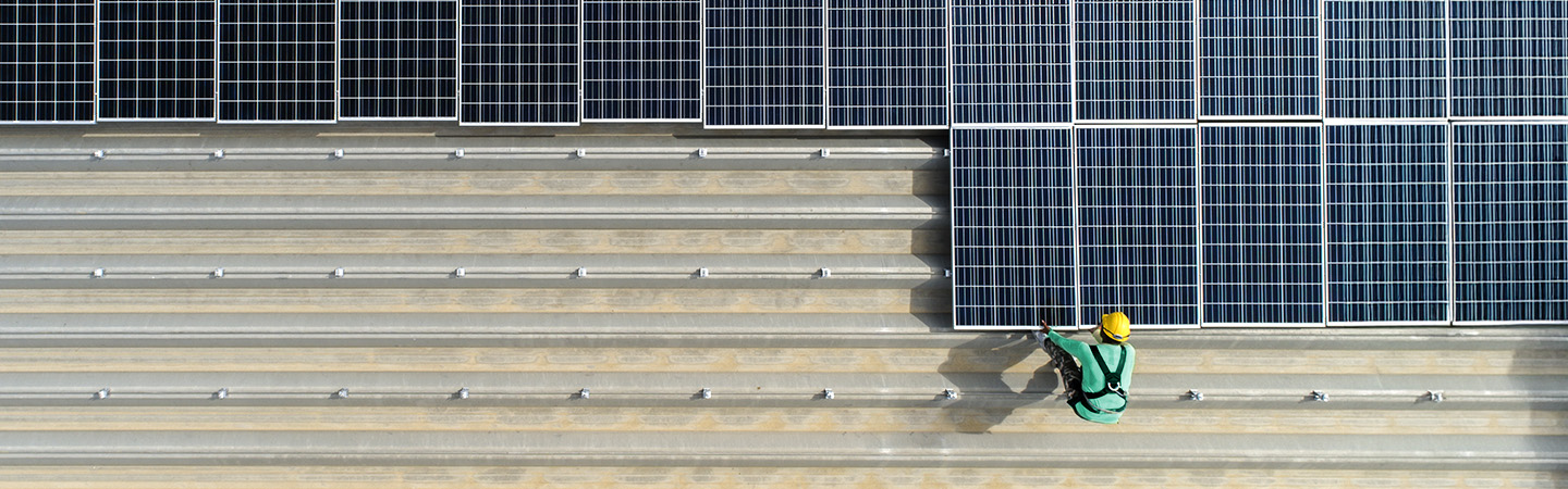A man placing solar panels.