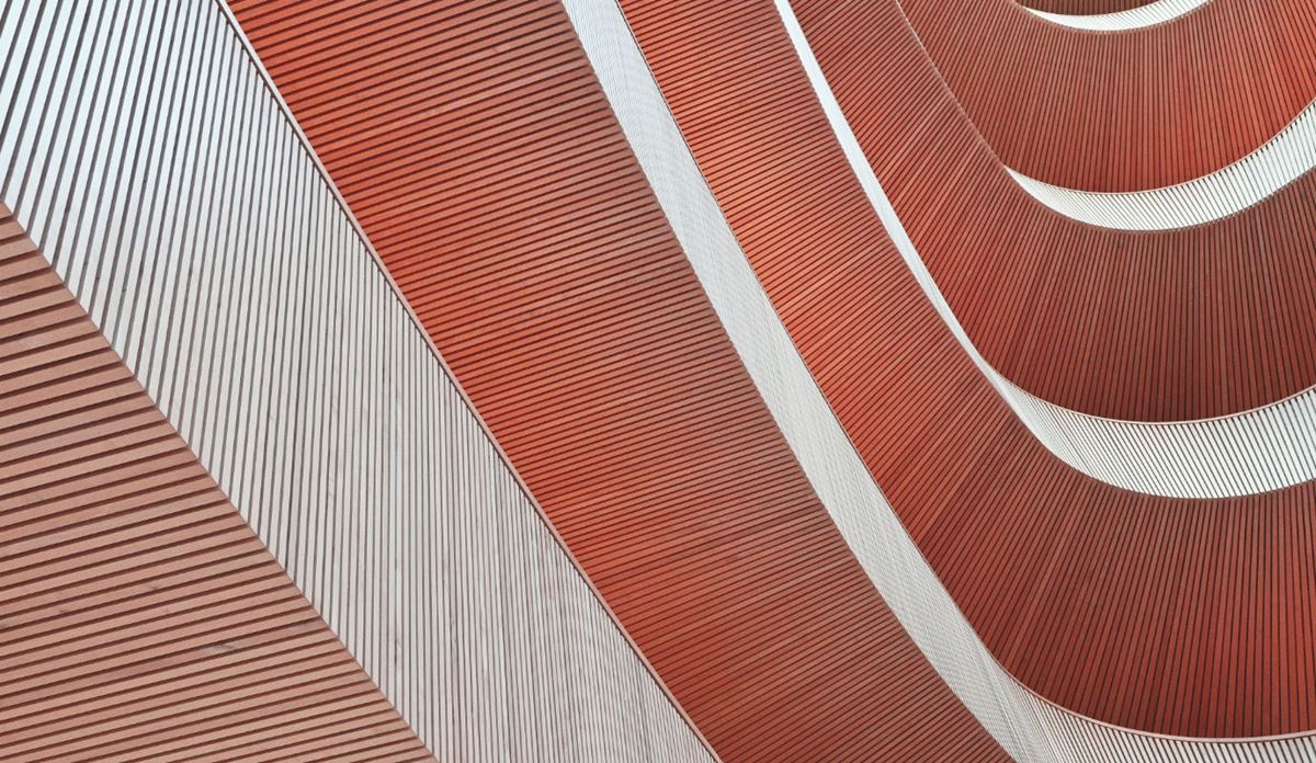 Detailed view of a building showcasing vibrant red and white stripes across its facade.