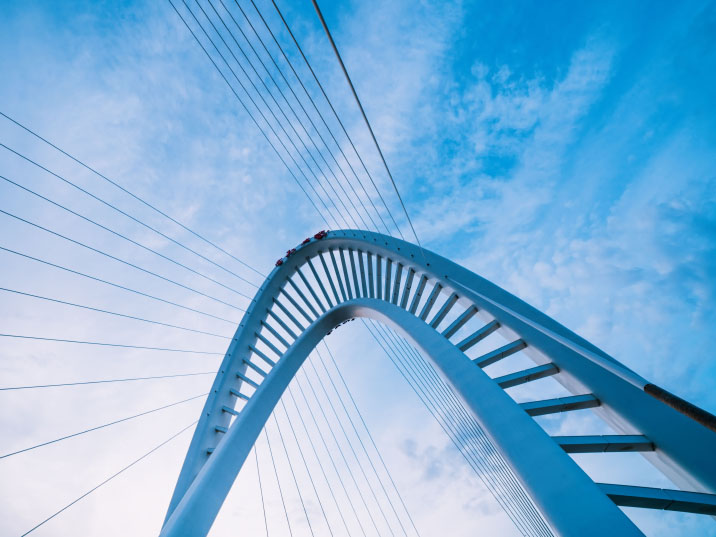 Curved bridge against a blue sky