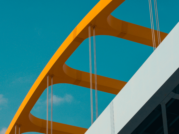 Artistic and geometric angle of the orange arches and structural framework of a bridge