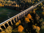 Railway viaduct crossing an autumn forest