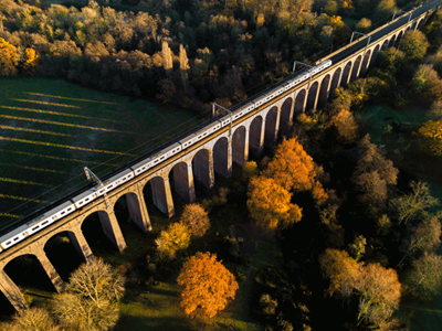 Railway viaduct crossing an autumn forest