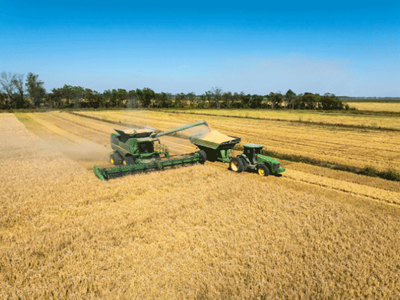 Farmland with a clear sky and tractor.