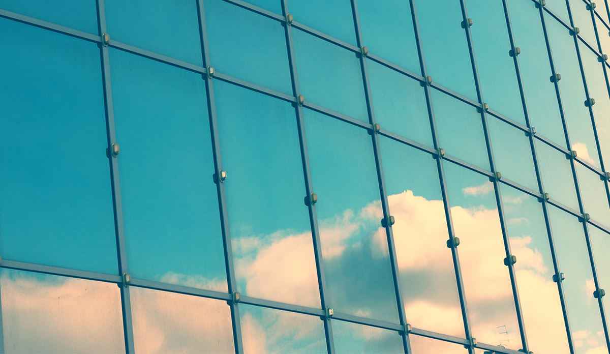 Glass window with reflection of sky
