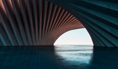 A spacious, curved tunnel with water flowing through it