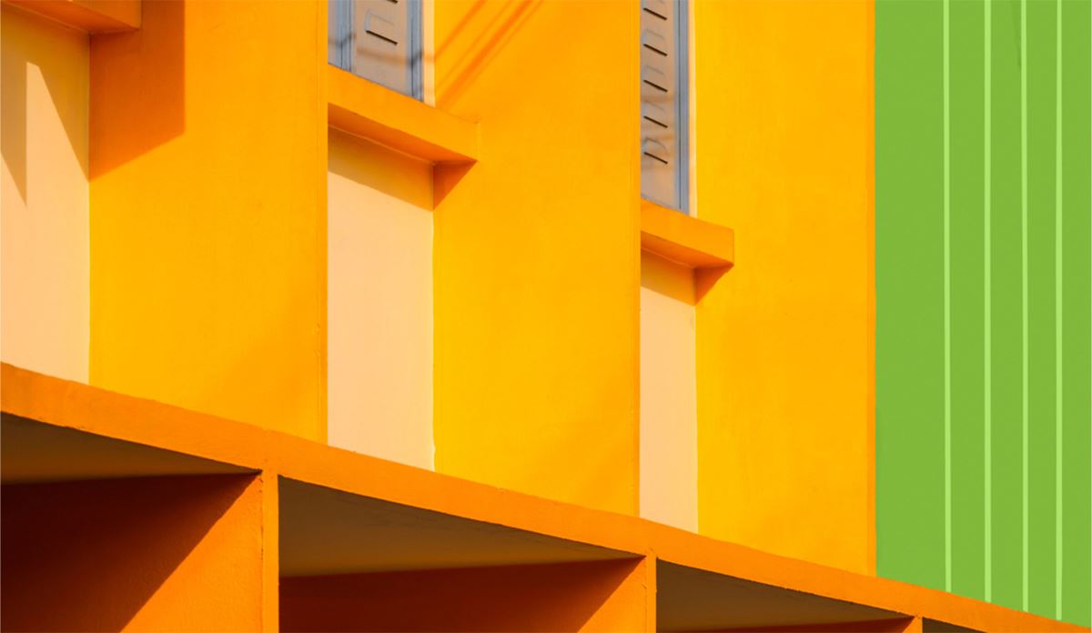 Detailed view of a building showcasing a striking green and yellow color palette, emphasizing its unique design elements.