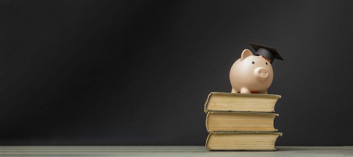 A piggy bank on a stack of books