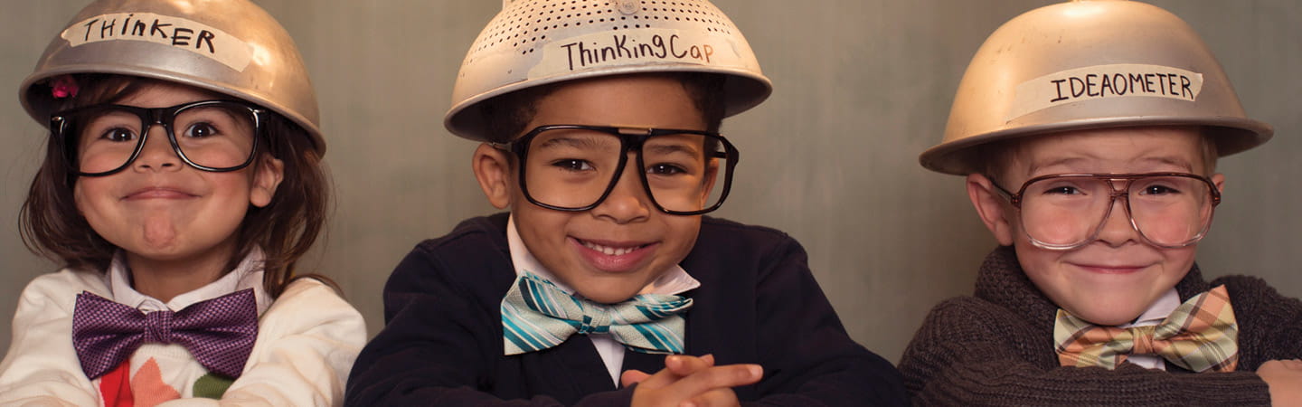Three children with thinking hats on
