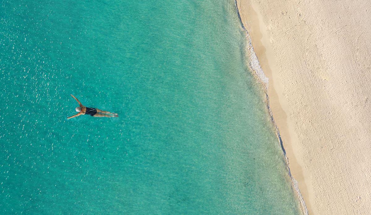 Snorkeler in tropical waters from above