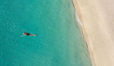 Snorkeler in tropical waters from above