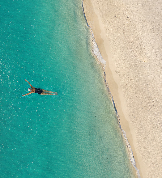 Snorkeler in tropical waters from above