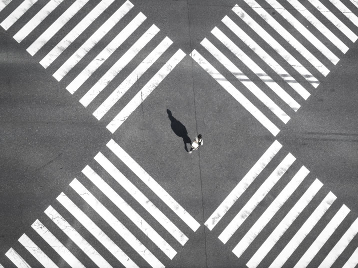 A person standing between crossroads.