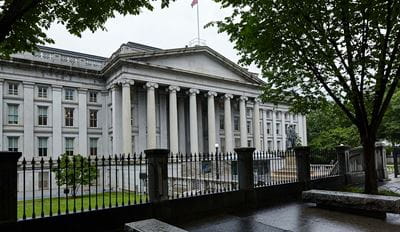 Treasury building behind iron fence.