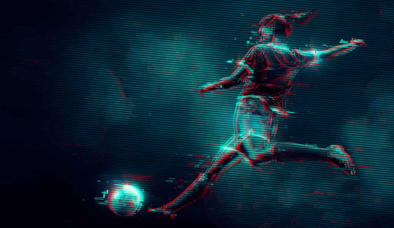 Soccer player kicking a ball with a dark background