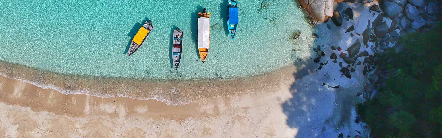 Image of beach shoreline with boats