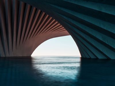 curved concrete structure framing a view of calm water