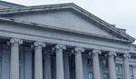 Front view of classical building with tall columns and triangular pediment.