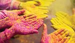 Hands covered in pink and yellow dust