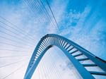 Curved bridge against a blue sky