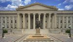 Front view of a large neoclassical government building with tall columns.