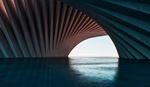 A spacious, curved tunnel with water flowing through it