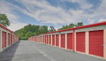 Row of outdoor storage units with metal roll-up doors