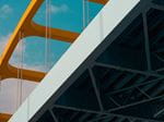 Modern bridge with orange arches and steel framework