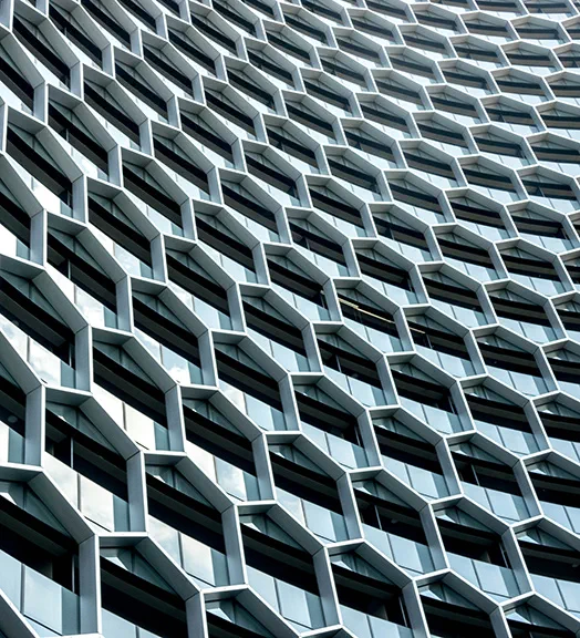 A multi-windowed building featuring a prominent clock on its facade
