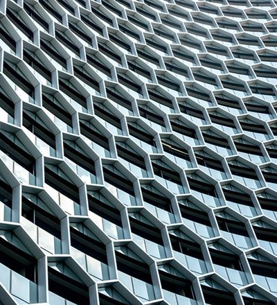 A multi-windowed building featuring a prominent clock on its facade