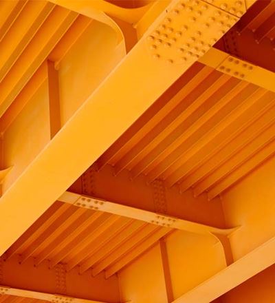 View of a bridge's underside showcasing multiple orange beams