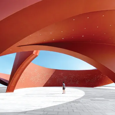 Small figure standing in architectural sculpture
