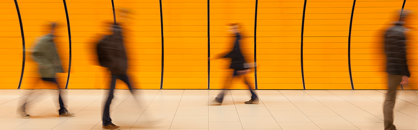 A hazy view of individuals walking in a hallway