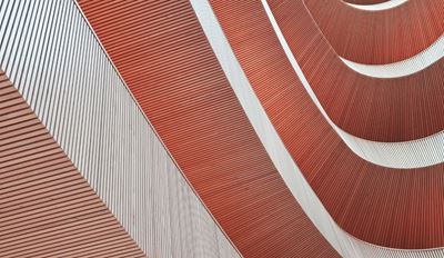 Detailed view of a building showcasing vibrant red and white stripes across its facade.