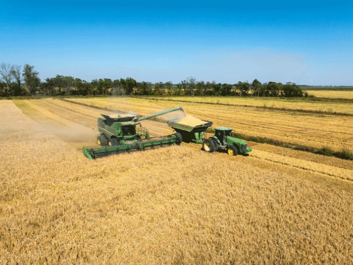 Farmland with a clear sky and tractor.