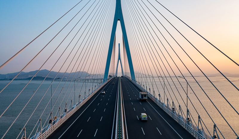 Vehicles moving on a bridge.