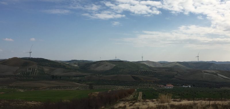 Wind turbines on hills in background