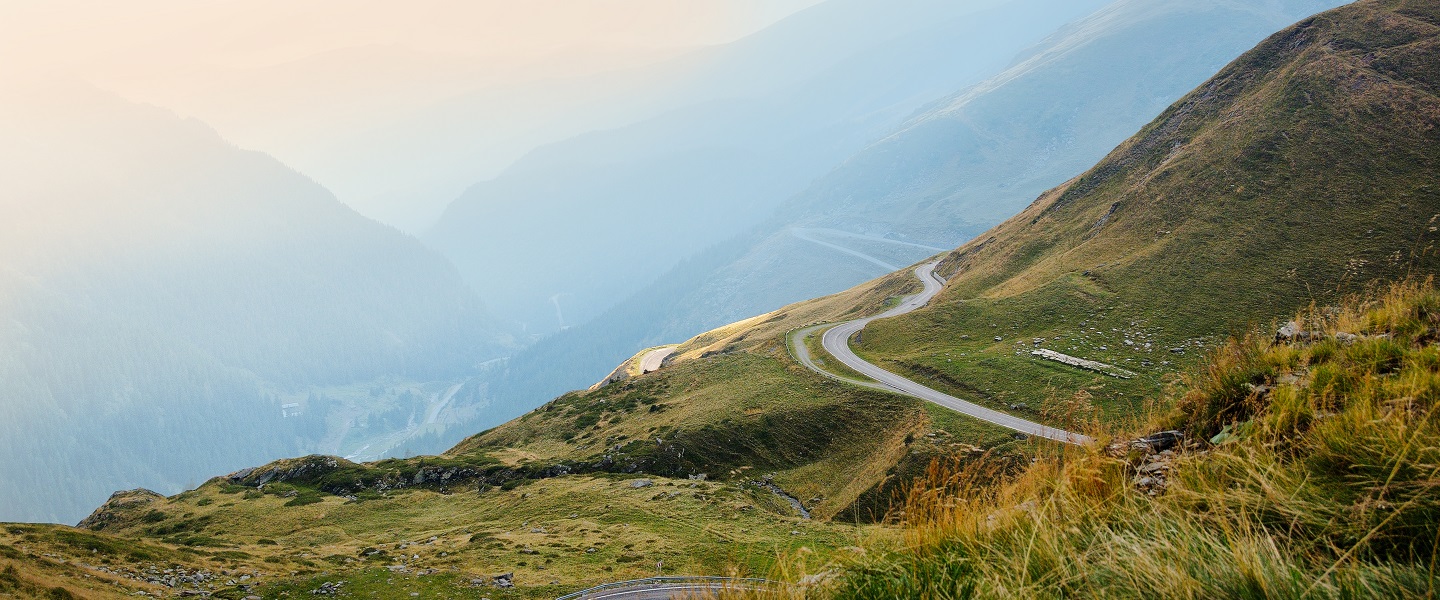 A road through grassy hills