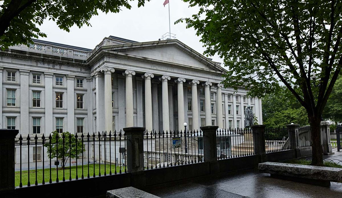 Treasury building behind iron fence.