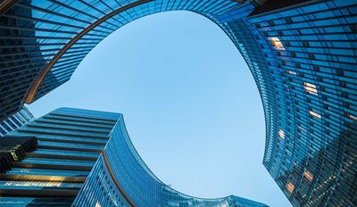 View looking up at modern glass skyscrapers