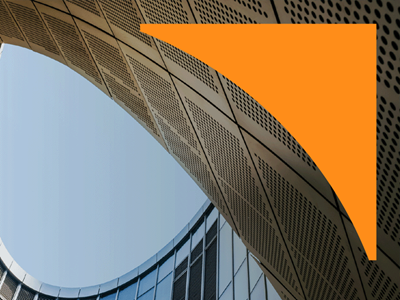 Close-up of a curved architectural structure with warm amber tones and parallel ridges, with an orange geometric shape in the upper right corner.