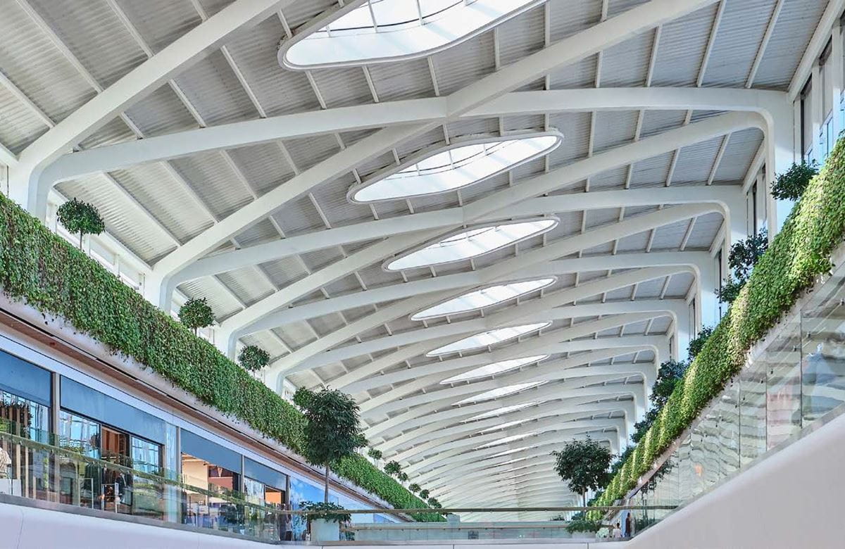 Bright atrium with green walls and architectural ceiling