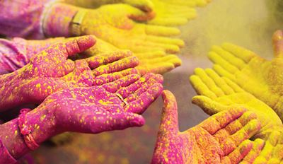 Hands covered in pink and yellow dust