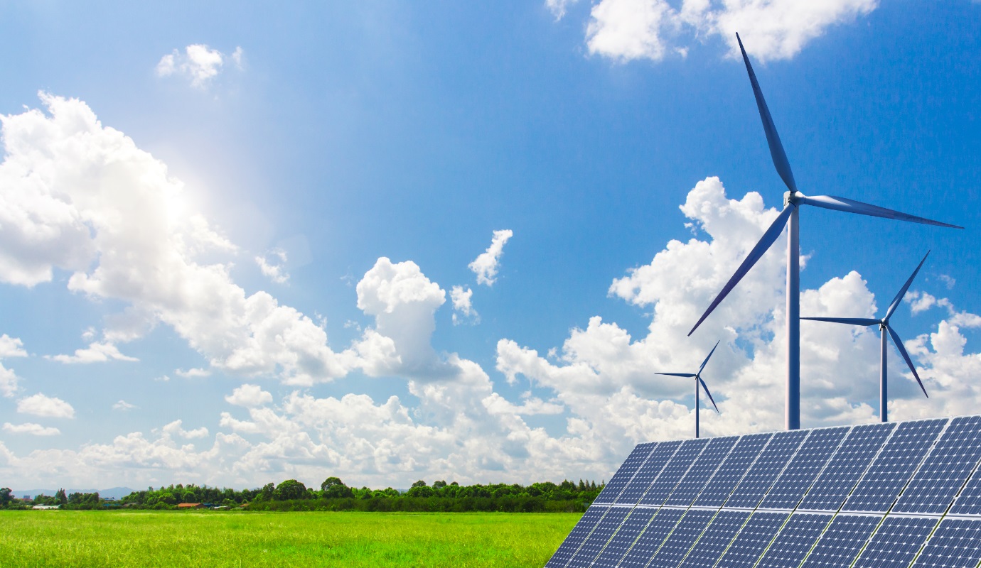 Wind turbines and solar panels in a picturesque field