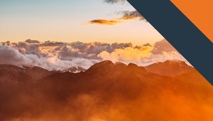 The tops of a cloudy mountain range during a sunset