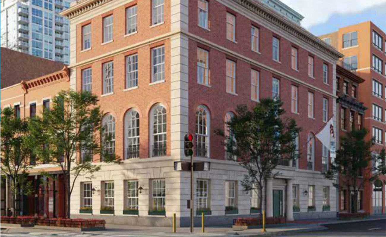 Red brick building featuring multiple windows, showcasing a classic architectural style.