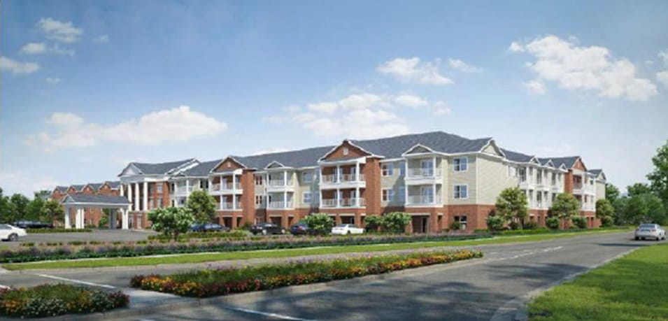 Architectural rendering of Charter Senior Living Sheboygan showing a three-story modern residential building with red brick and cream-colored siding.